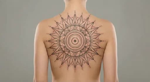 geometric sun tattoo on the back