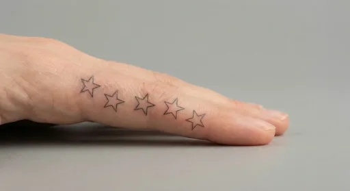 fine line stars tattoo on the finger