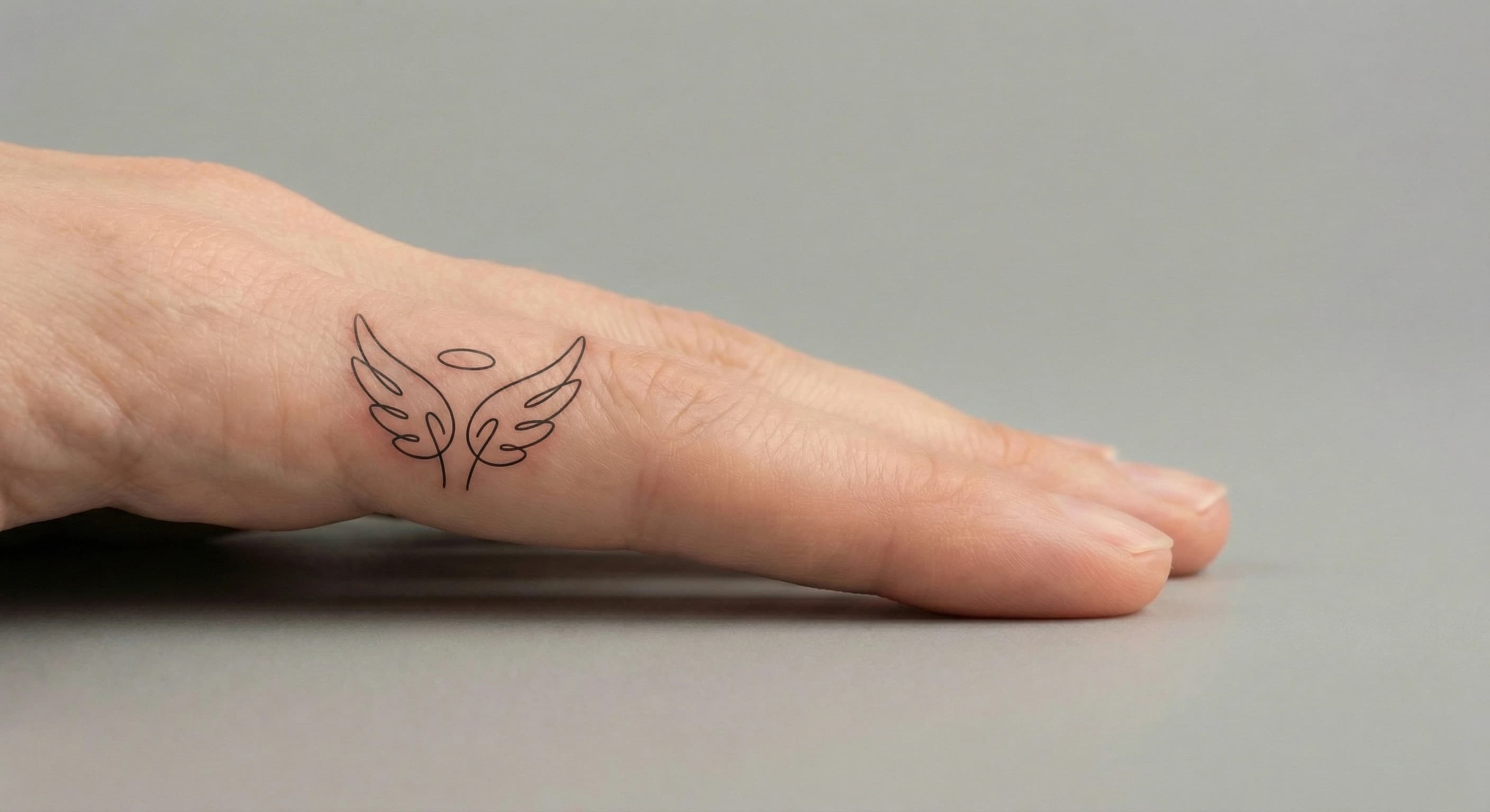 minimal angel numbers tattoo on the finger